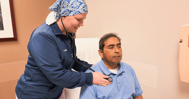 Line Hinojosa checking a patient's vital signs.