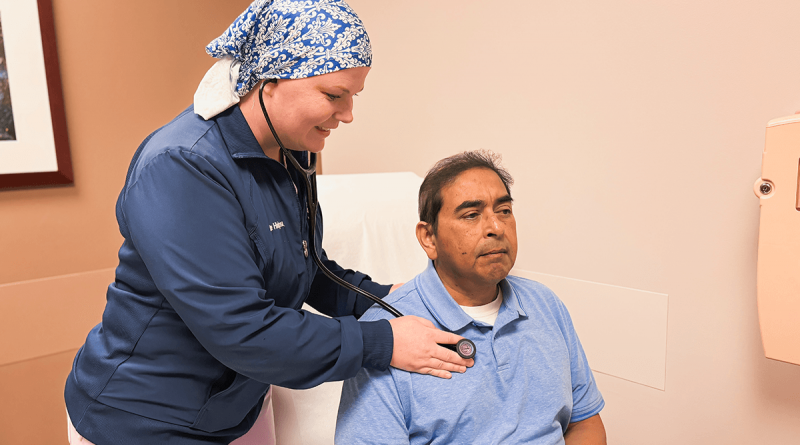 Line Hinojosa checking a patient's vital signs.