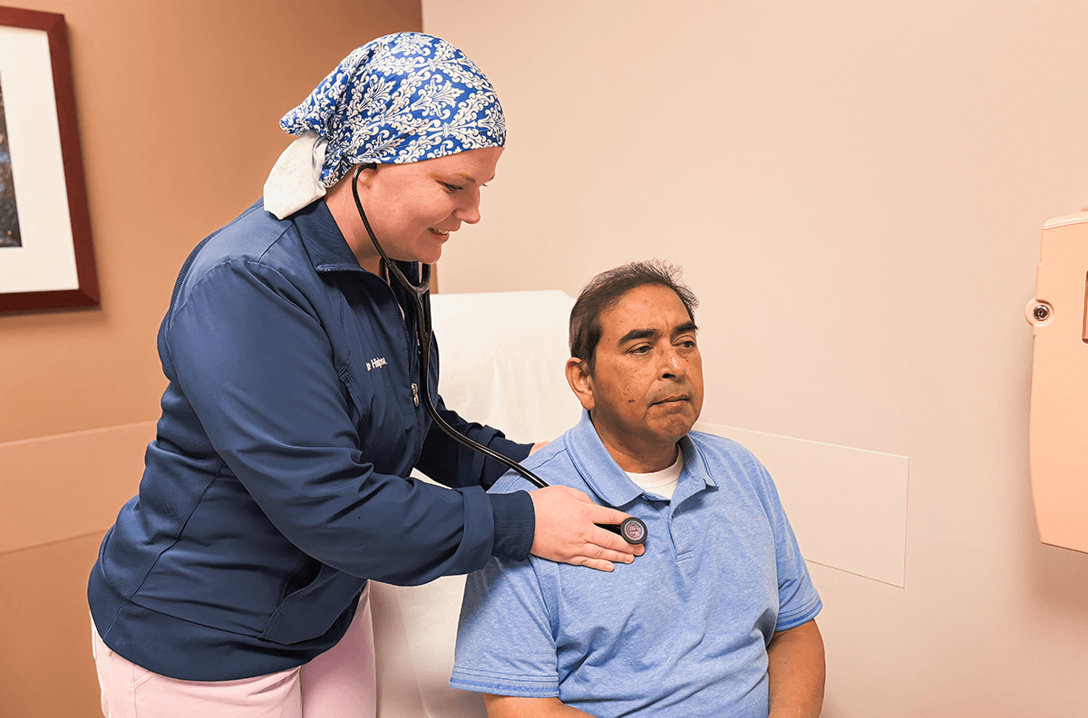 Line Hinojosa checking a patient's vital signs.