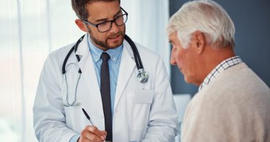 Shot of a doctor writing notes while examining a senior patient in a clinic