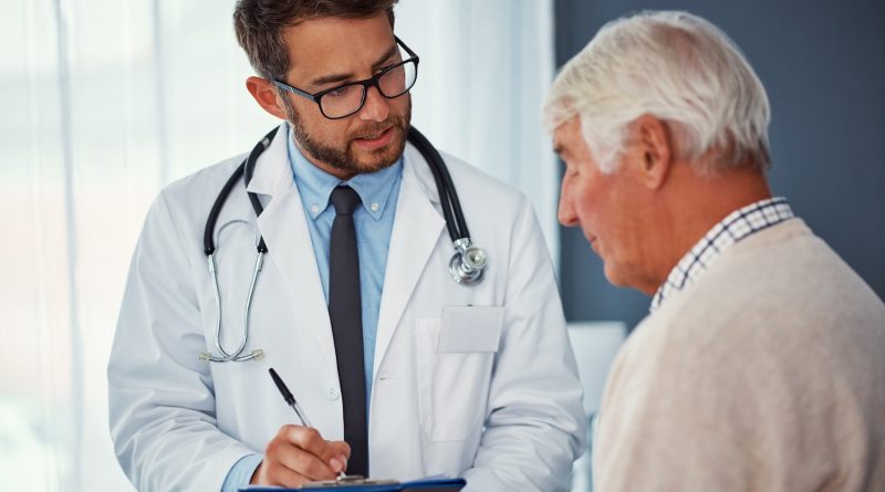 Shot of a doctor writing notes while examining a senior patient in a clinic