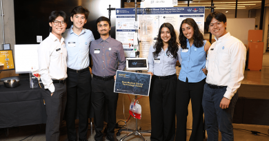 Six members of Team Uroflo pose with their device between them. The device features a bad of red liquid attached to a touch screen.