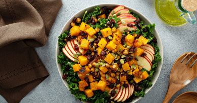 A bright yellow and green fall salad, with apples slices, cranberries and squash.