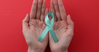 A light blue ribbon held in open hands.