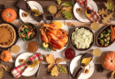 A vibrant and colorful Thanksgiving meal spread with turkey, mashed potatoes, Waldorf salad, pumpkin pie, Brussel's sprouts and carrots.