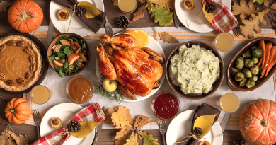 A vibrant and colorful Thanksgiving meal spread with turkey, mashed potatoes, Waldorf salad, pumpkin pie, Brussel's sprouts and carrots.