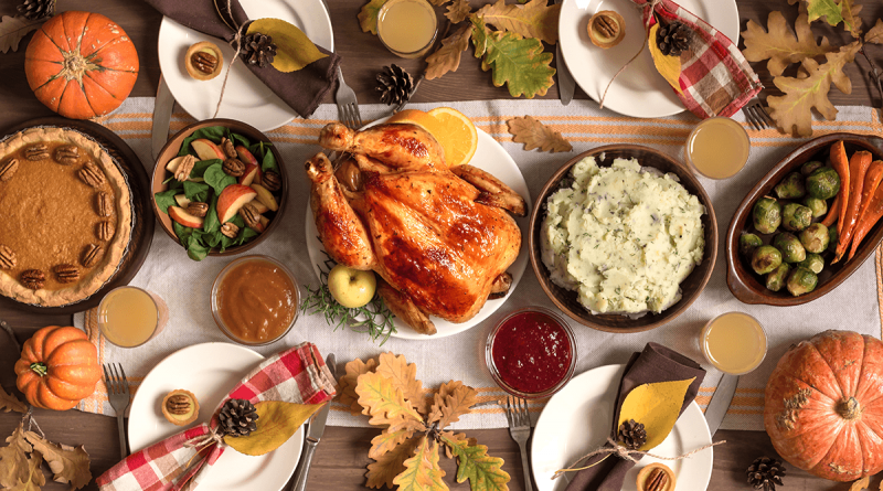 A vibrant and colorful Thanksgiving meal spread with turkey, mashed potatoes, Waldorf salad, pumpkin pie, Brussel's sprouts and carrots.