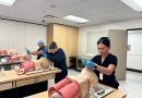 Three students practicing breathing assistance with mannequins.