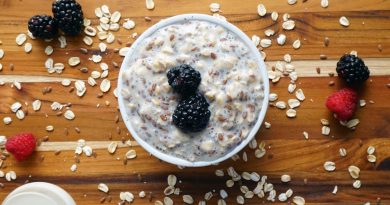 Breakfast oatmeal with mixed berries and almond slices.