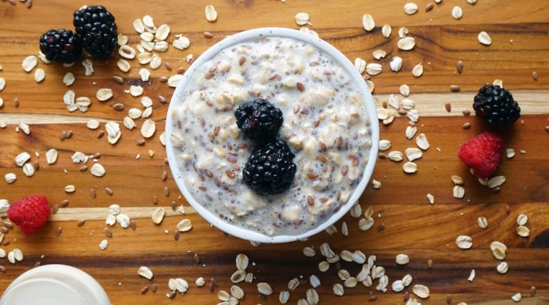 Breakfast oatmeal with mixed berries and almond slices.