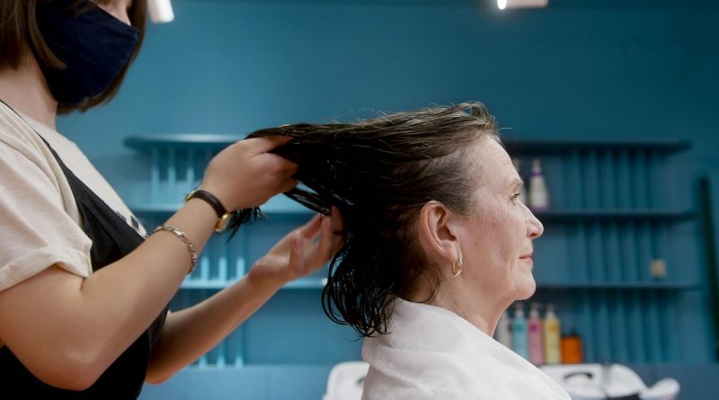 Older woman having her hair cut at a salon.