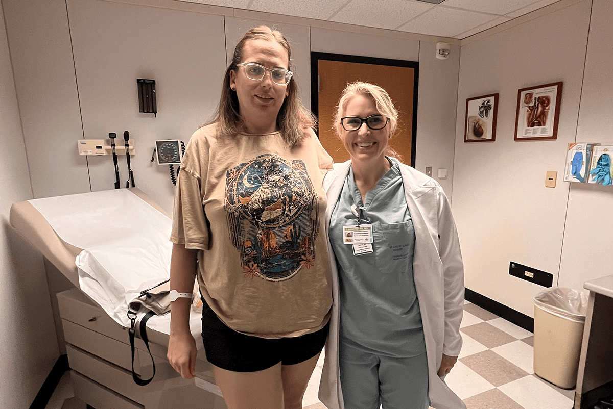 Jessica Wilbourn and Dr. Lauren Barron stand together in an exam room.