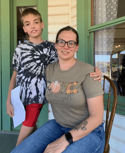 Jessica Wilbourn seated next to her standing son.