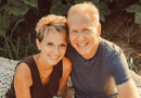 Keri Carlson sitting outdoors in the sun next to her husband.