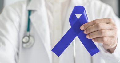 Doctor holding colon cancer awareness ribbon