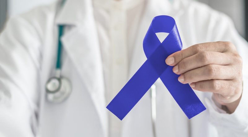 Doctor holding colon cancer awareness ribbon