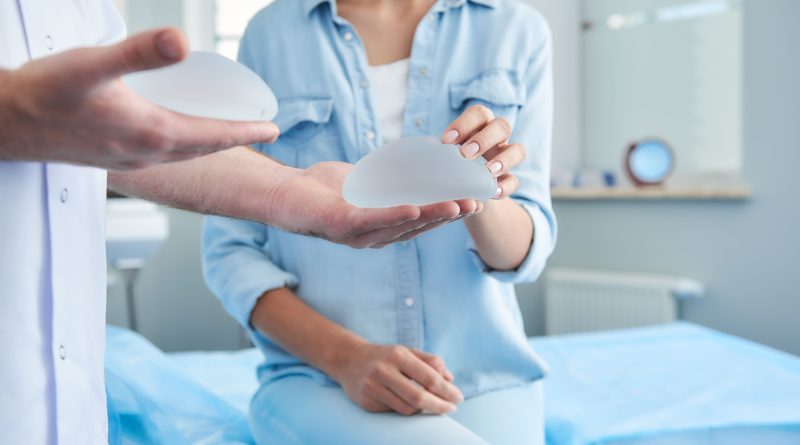 Doctor shows patient implants while patient feels them.