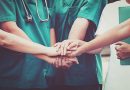 Healthcare team joins hands in unity.