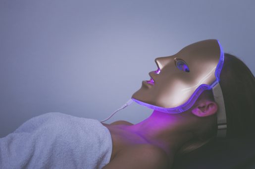 Woman with LED Light Therapy mask on her face.