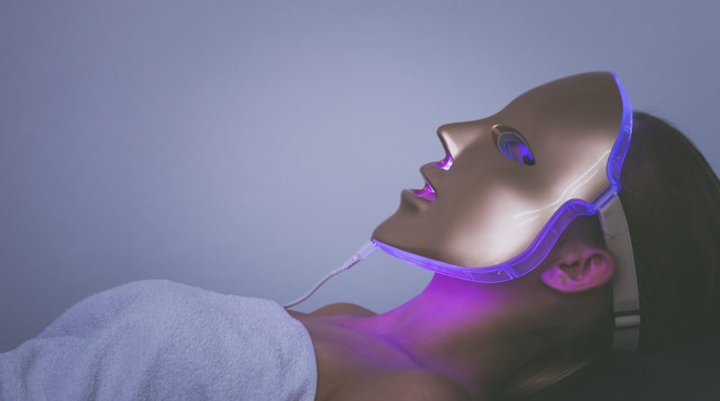 Woman with LED Light Therapy mask on her face.