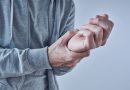 Person holding their wrist due to pain.