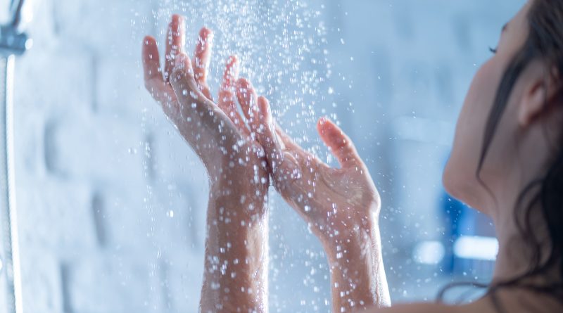 A woman's two hands in the shower.