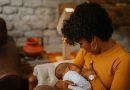Mom breastfeeds newborn baby.
