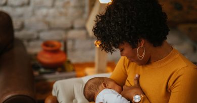 Mom breastfeeds newborn baby.