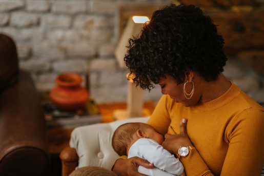 Mom breastfeeds newborn baby.