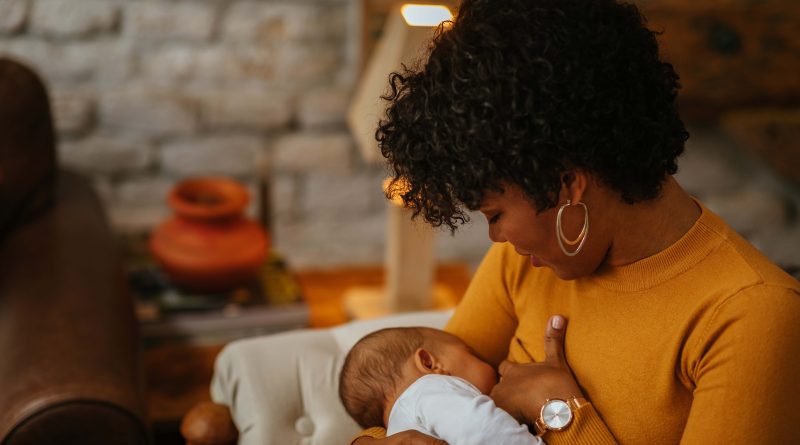 Mom breastfeeds newborn baby.