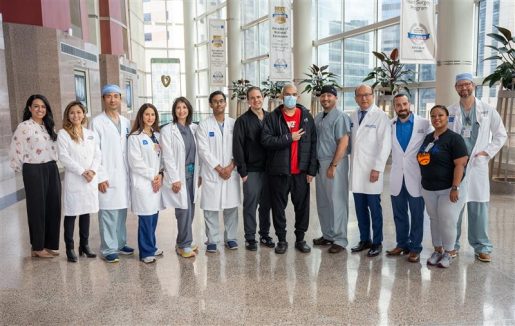 A patient posing with surgical team.