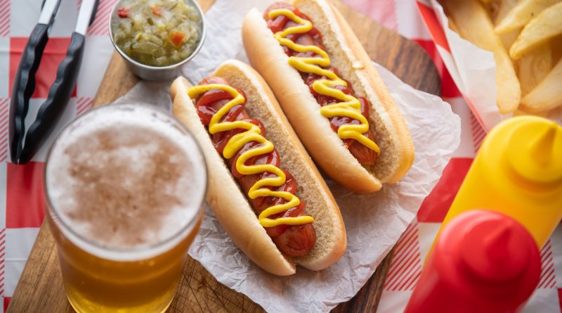 Two hot dogs with beer.