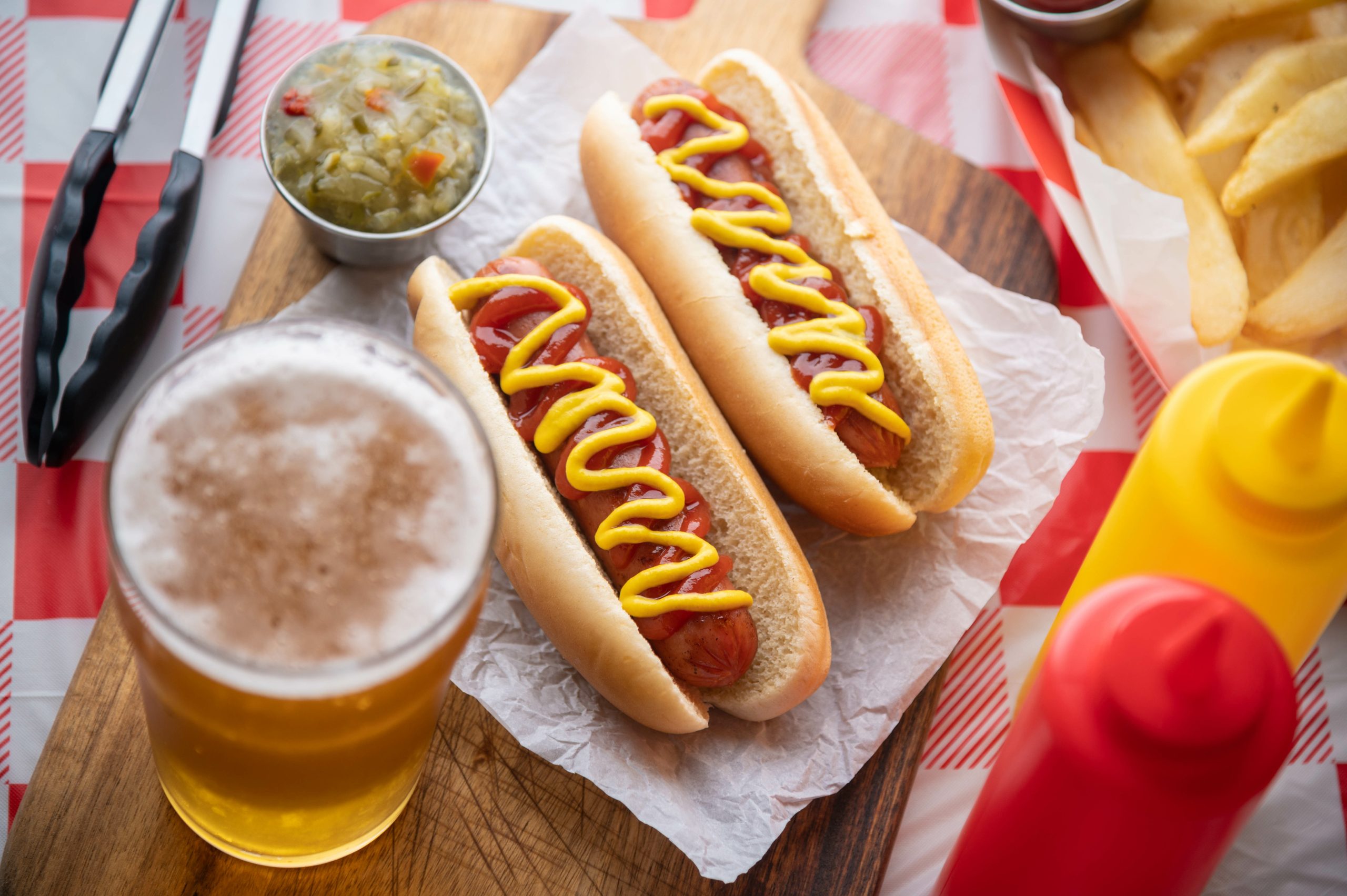 Two hot dogs with beer.