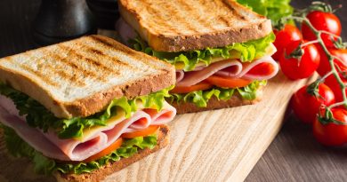 Two sandwiches on a board.