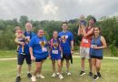 Mary Lara posing with a group at a 5K.