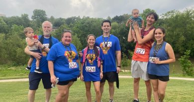 Mary Lara posing with a group at a 5K.
