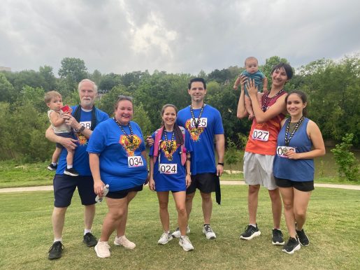 Mary Lara posing with a group at a 5K.