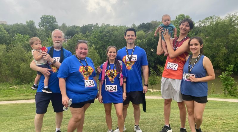 Mary Lara posing with a group at a 5K.