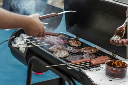 Person grilling meat.