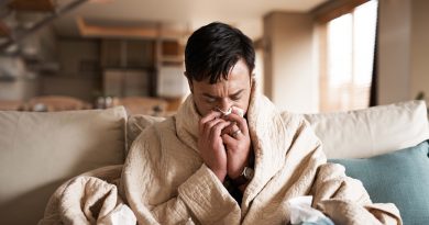 Sick man blowing his nose.