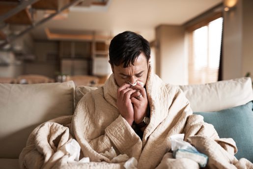 Sick man blowing his nose.