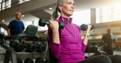 Woman holding dumbbells.