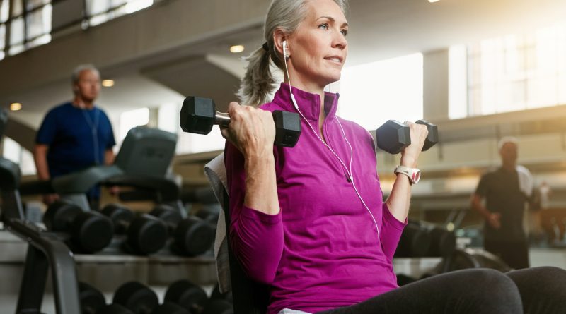 Woman holding dumbbells.
