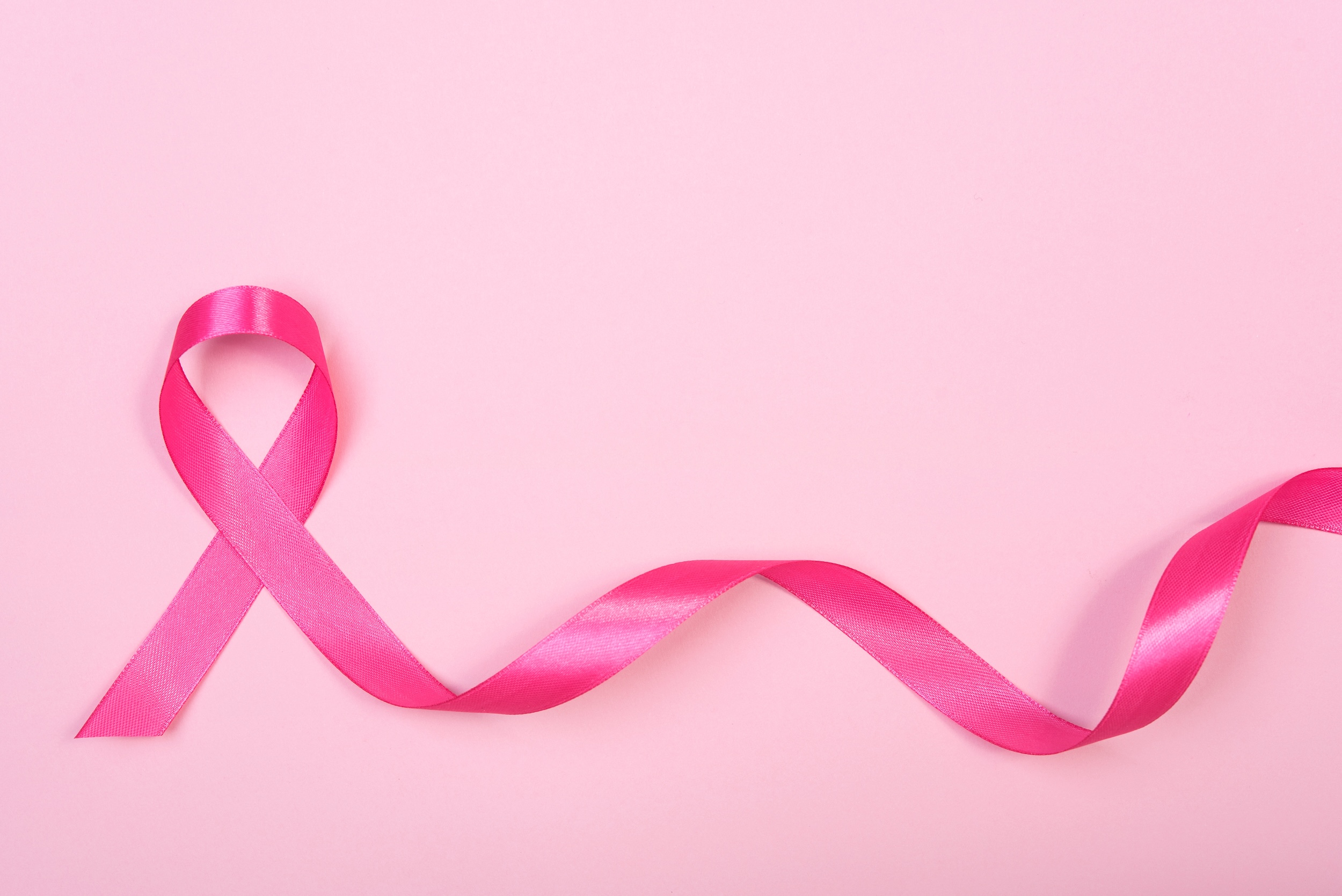 pink ribbon breast cancer on pink background.
