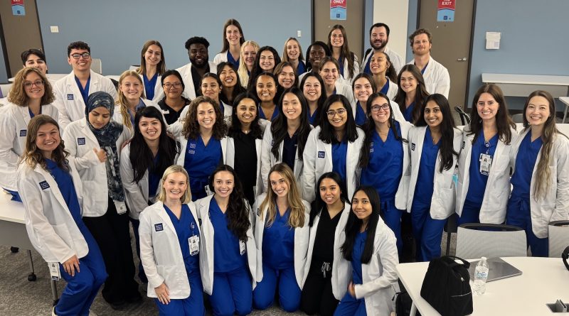 The Physician Assistant class of 2027 posing for a photo in classroom.