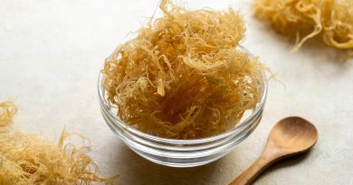 Sea moss: Healthy or just a trend? Close up of golden dried Sea Moss in a clear bowl with a wooden spoon.