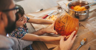 Handle with care: Avoiding hand injuries during Halloween pumpkin carving Little girl and her father holding a Halloween pumpkin. Family spending time together.