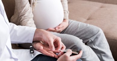 A person is checking blood sugar glucose of pregnant woman at home.