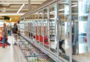 Frozen food aisle with glass door freezers in supermarket