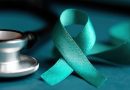 Teal awareness ribbon for ovarian cancer, cervical cancer, sexual assault, and polycystic ovary syndrome near a stethoscope on a table